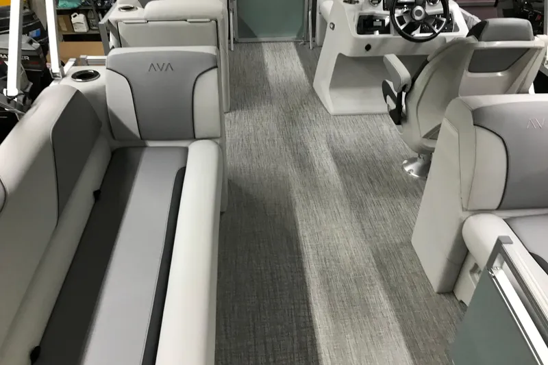 Slide: The Image of Interior of 2026 Avalon Venture Quad Lounger 19' with modern seating and steering console. - 33