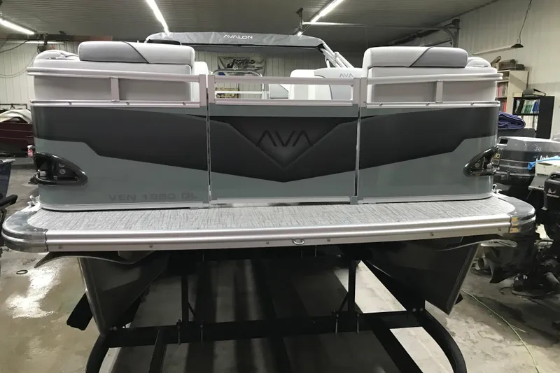 Slide: The Image of 2026 Avalon Venture Quad Lounger 19' pontoon boat in a showroom setting. - 6