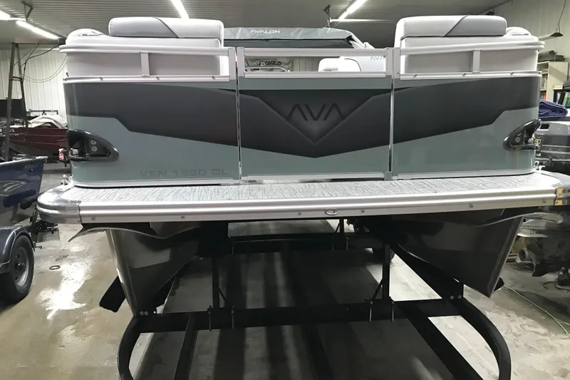Slide: The Image of 2026 Avalon Venture Quad Lounger 19' pontoon boat in a showroom setting. - 9