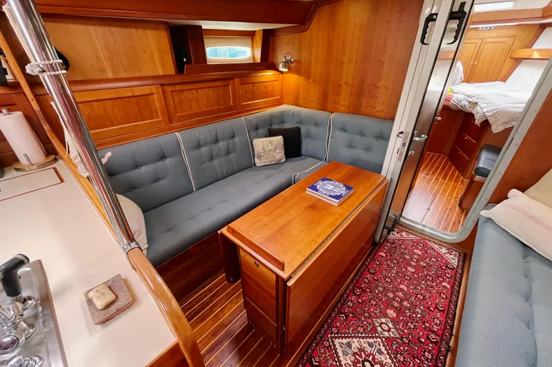 Slide: The Image of Luxurious interior of 1995 Able Apogee 50 yacht with cozy seating and elegant wood finish. - 9