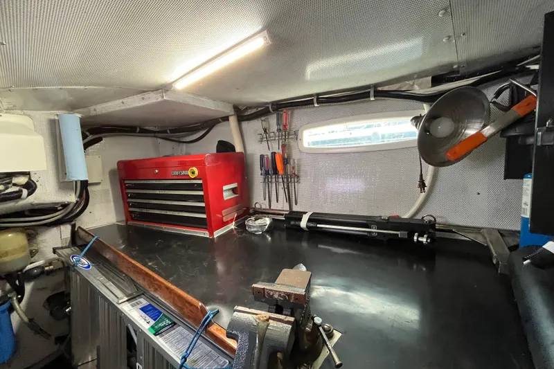 Slide: The Image of Workshop interior with tools, red toolbox, and workbench inside a 1995 Able Apogee 50. - 31