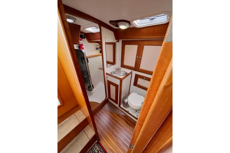 Slide: The Image of Interior of 1995 Able Apogee 50 yacht bathroom with wooden accents and compact design. - 17