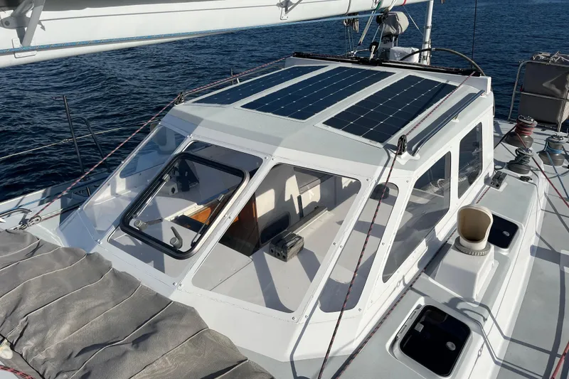 Slide: The Image of Sailboat deck with solar panels on Able Apogee 50, 1995 model, on calm sea. - 44