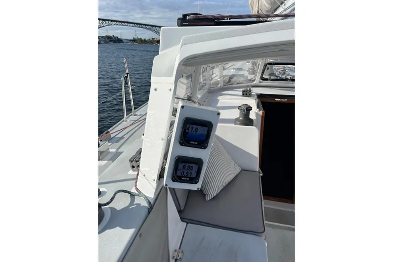 Slide: The Image of Cockpit of 1995 Able Apogee 50 sailboat with navigation instruments and water view. - 57