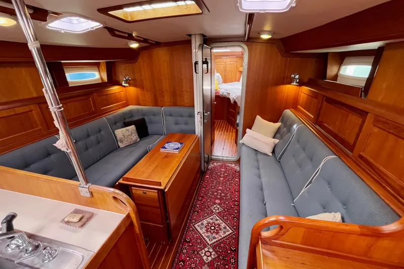 Slide: The Image of Luxurious 1995 Able Apogee 50 yacht interior with wooden paneling and cozy seating. - 8