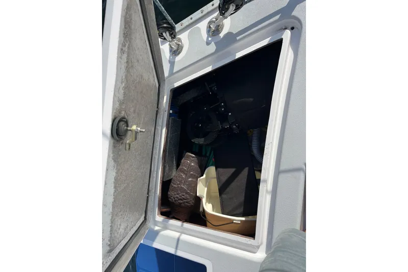 Slide: The Image of Open hatch on 1995 Able Apogee 50 boat, revealing interior storage space. - 68