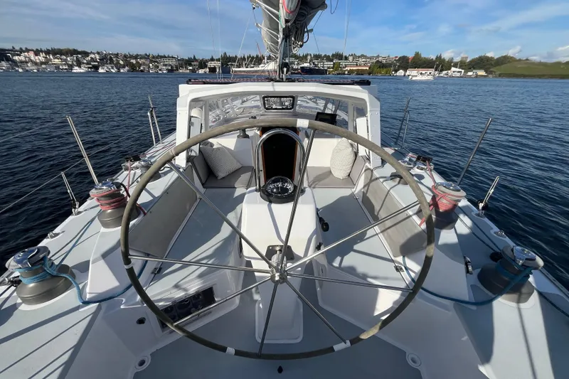Slide: The Image of Sailboat cockpit view, Able Apogee 50, 1995 model, on calm water with scenic background. - 46