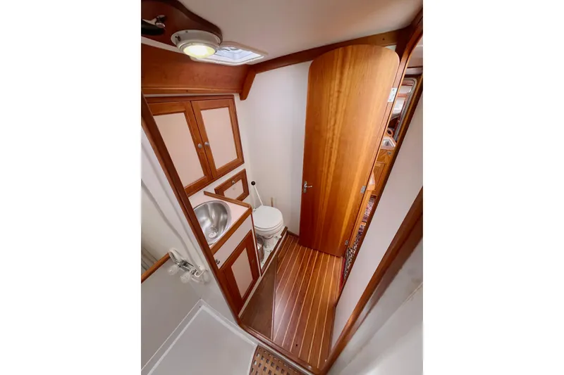 Slide: The Image of 1995 Able Apogee 50 yacht bathroom with wooden cabinetry and compact design. - 19