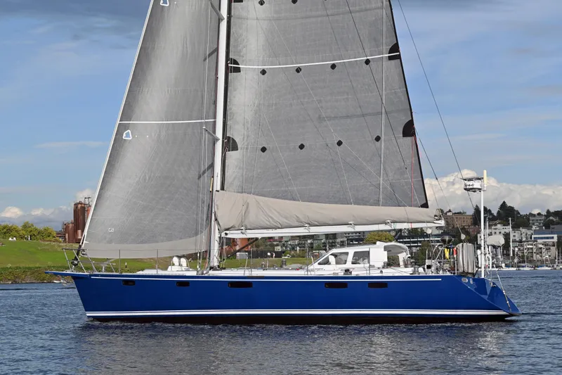 Slide: The Image of Blue Able Apogee 50 sailboat from 1995 on calm water, cityscape background. - 80
