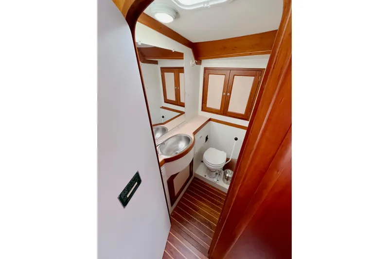 Slide: The Image of 1995 Able Apogee 50 yacht bathroom with wooden cabinetry and stainless steel sink. - 4