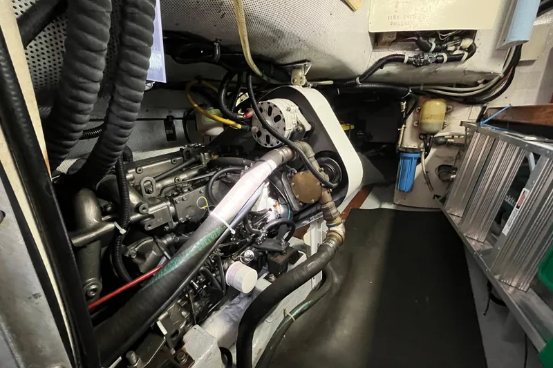 Slide: The Image of Engine room of a 1995 Able Apogee 50 sailboat, showcasing mechanical components and wiring. - 32