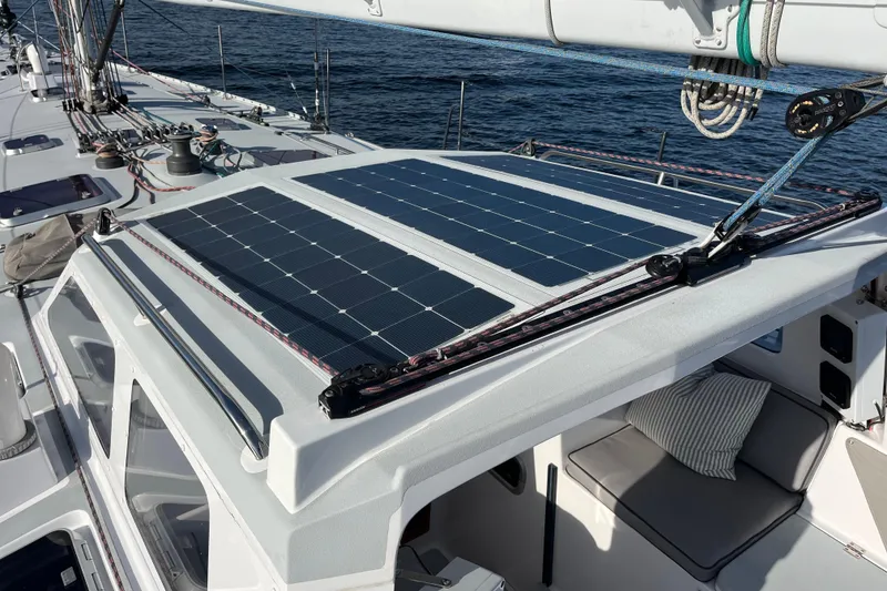 Slide: The Image of Sailboat with solar panels on deck, Able Apogee 50, 1995 model, cruising on water. - 45