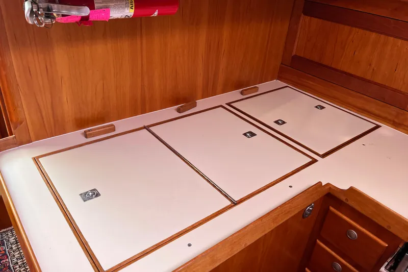 Slide: The Image of Wooden interior of 1995 Able Apogee 50 yacht with storage compartments and fire extinguisher. - 22