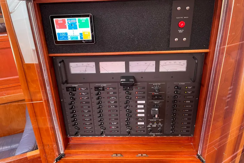 Slide: The Image of Electrical control panel of a 1995 Able Apogee 50 yacht with gauges and switches. - 28