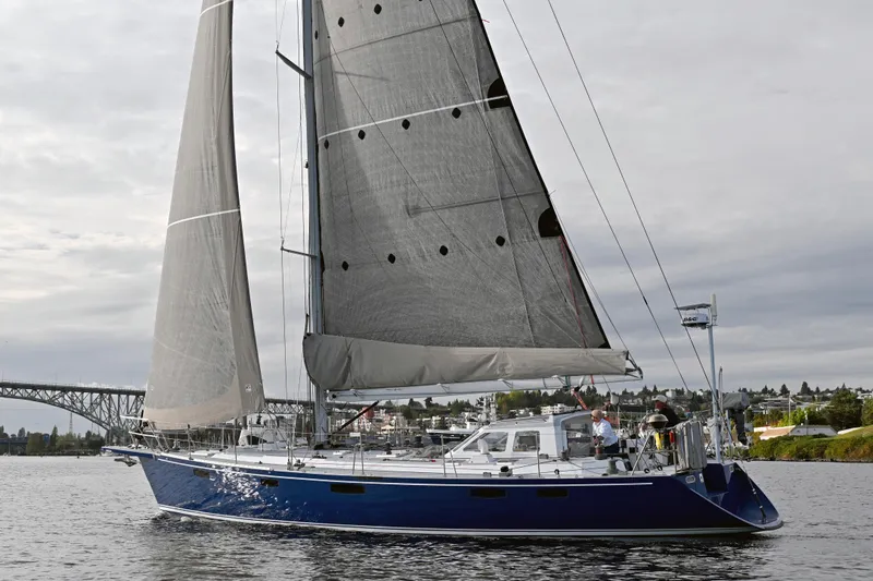 Slide: The Image of Sailing yacht Able Apogee 50 from 1995 on calm waters, with cityscape background. - 76