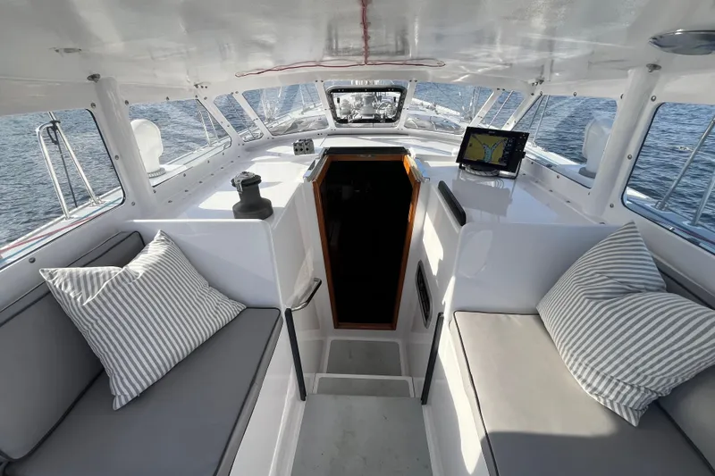Slide: The Image of Interior of 1995 Able Apogee 50 sailboat with striped cushions and navigation equipment. - 51