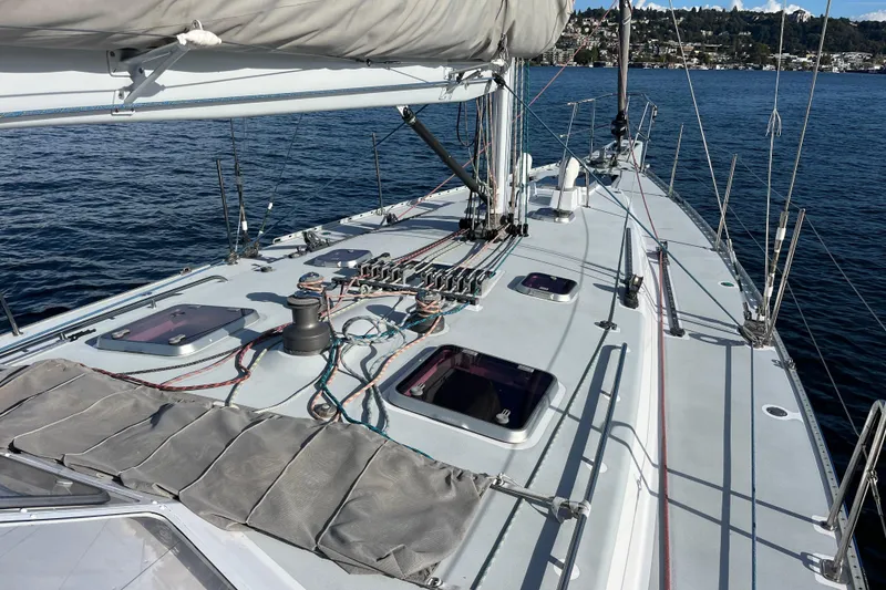 Slide: The Image of Sailboat deck of 1995 Able Apogee 50 on calm water, featuring rigging and hatches. - 40