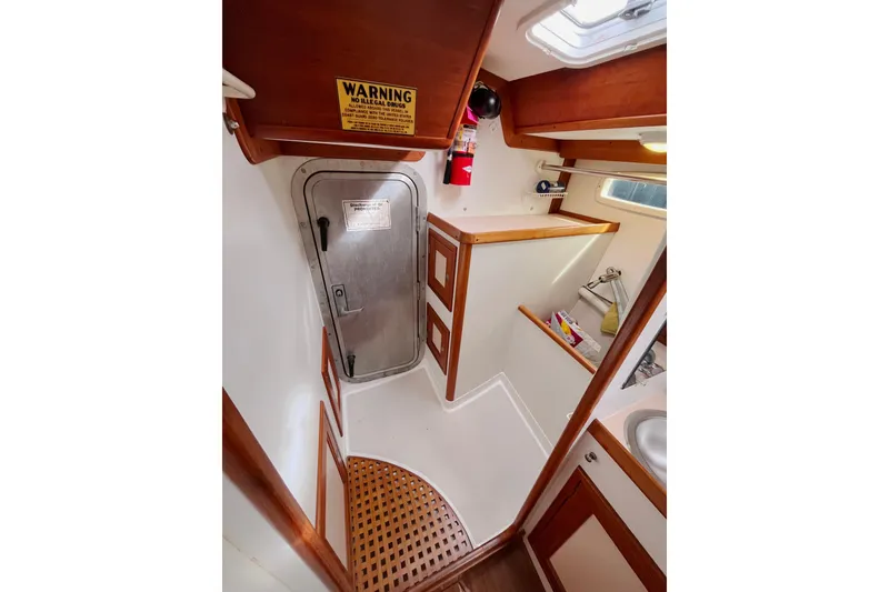 Slide: The Image of Interior of 1995 Able Apogee 50 sailboat with wooden accents and metal door. - 18
