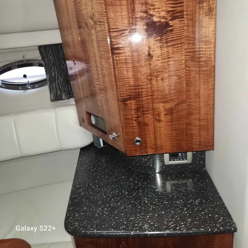 Slide: The Image of Interior of 2006 Formula 27 PC boat with wood cabinetry and speckled countertop. - 10