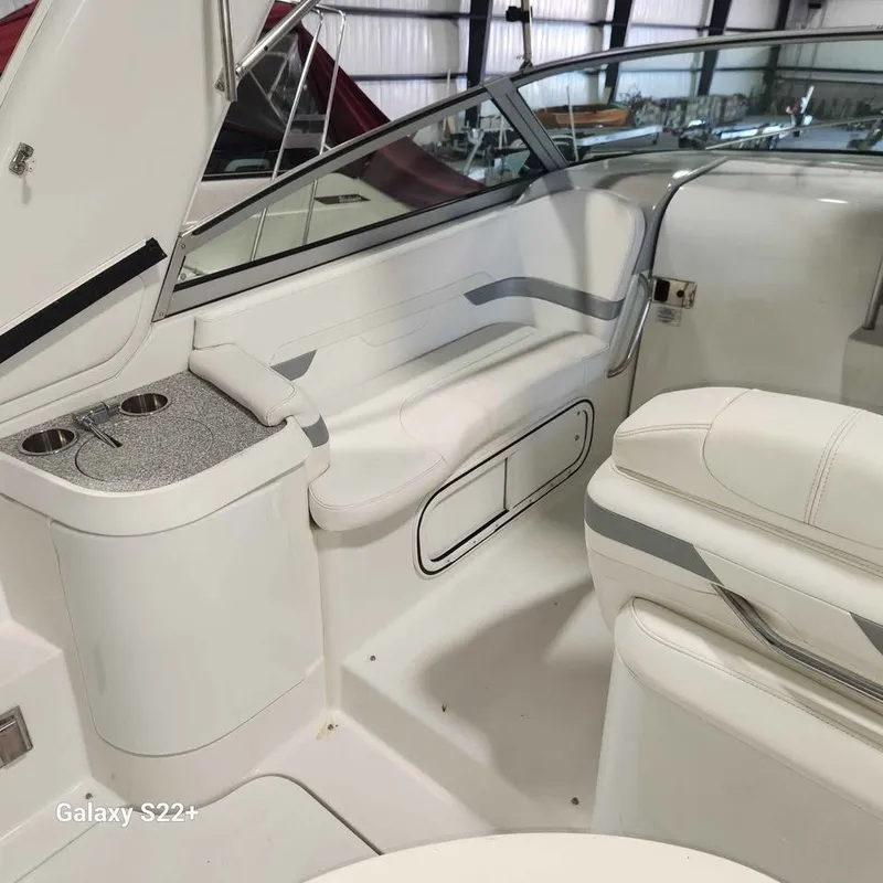 Slide: The Image of Interior of a 2006 Formula 27 PC boat with white seating and cup holders. - 11