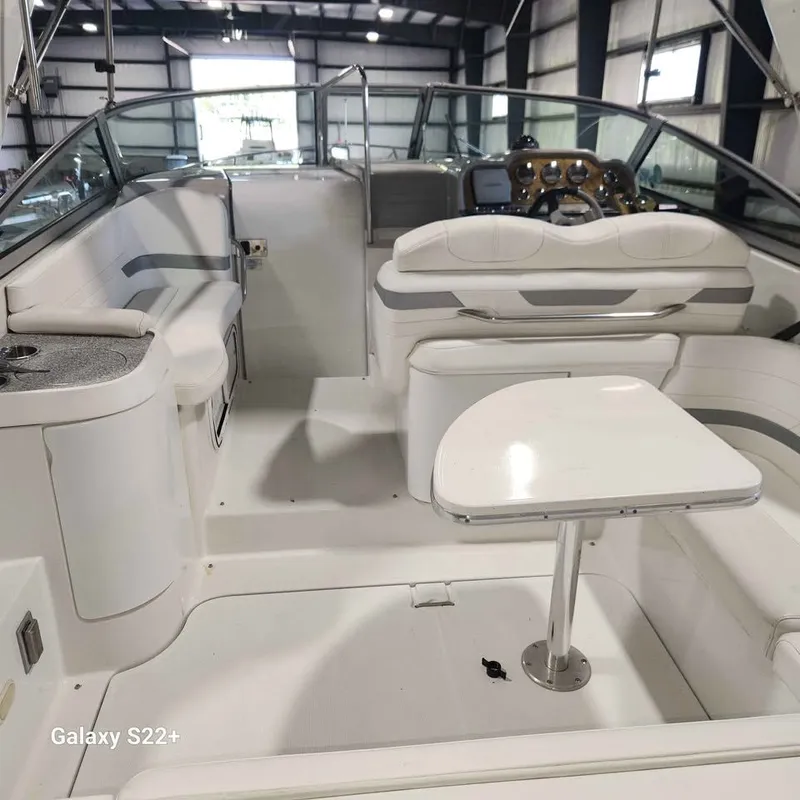 Slide: The Image of 2006 Formula 27 PC boat interior with seating and table in a showroom. - 13