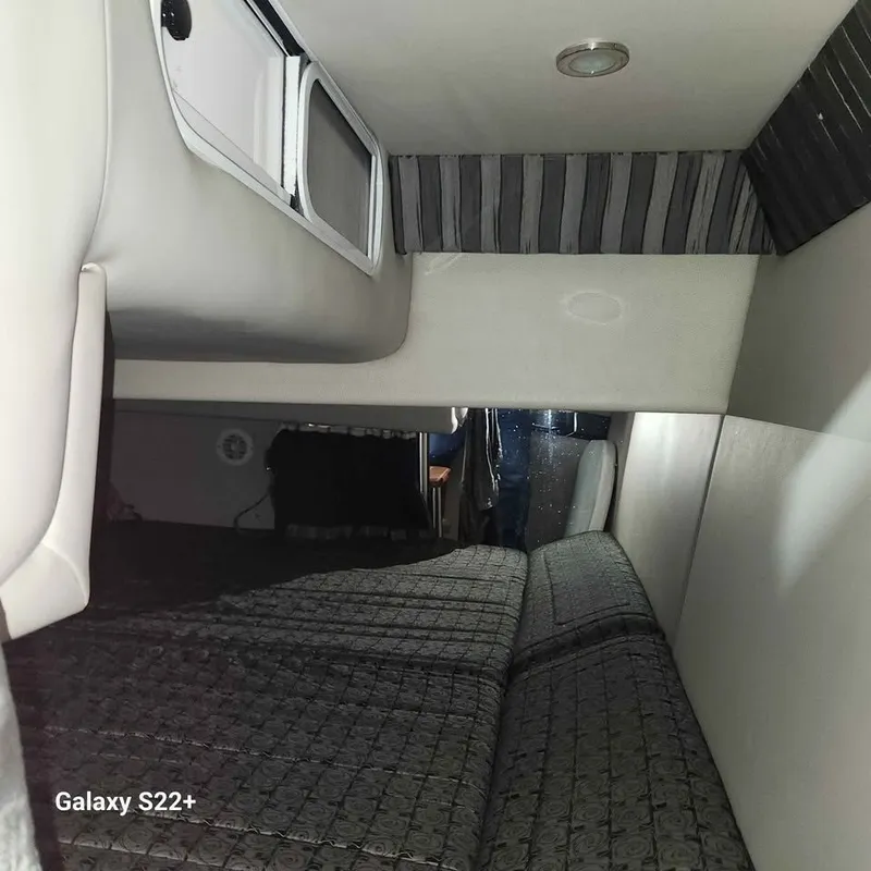 Slide: The Image of Interior cabin of a 2006 Formula 27 PC boat, featuring a cozy sleeping area. - 14