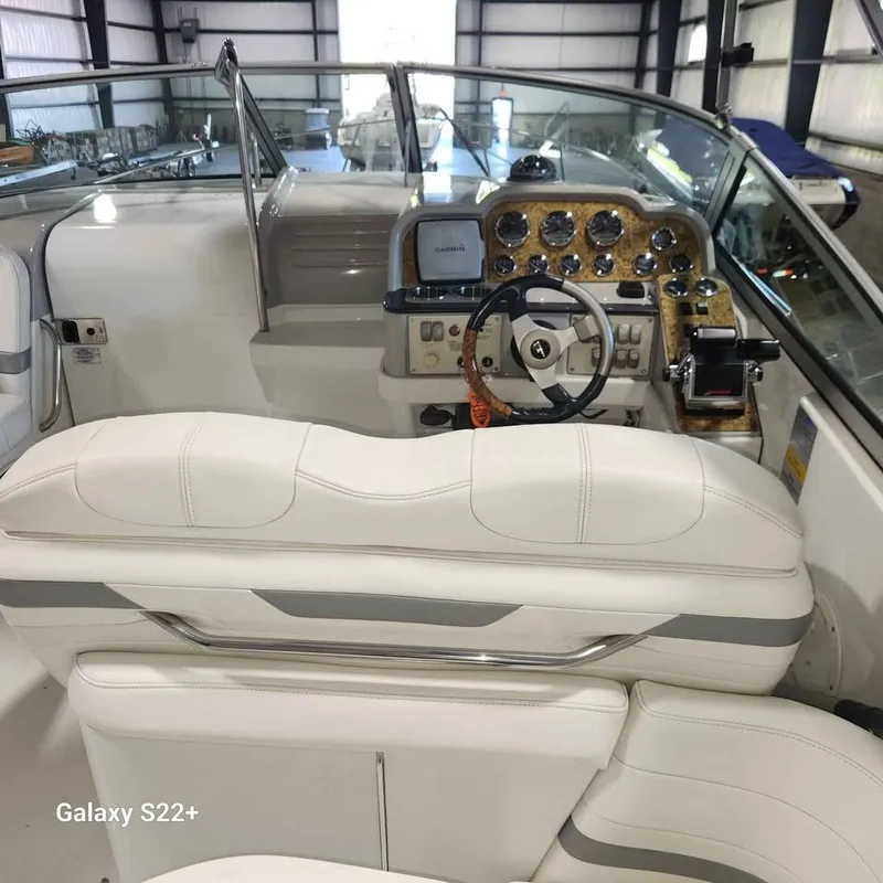 Slide: The Image of Interior of a 2006 Formula 27 PC boat with white seating and control panel. - 18