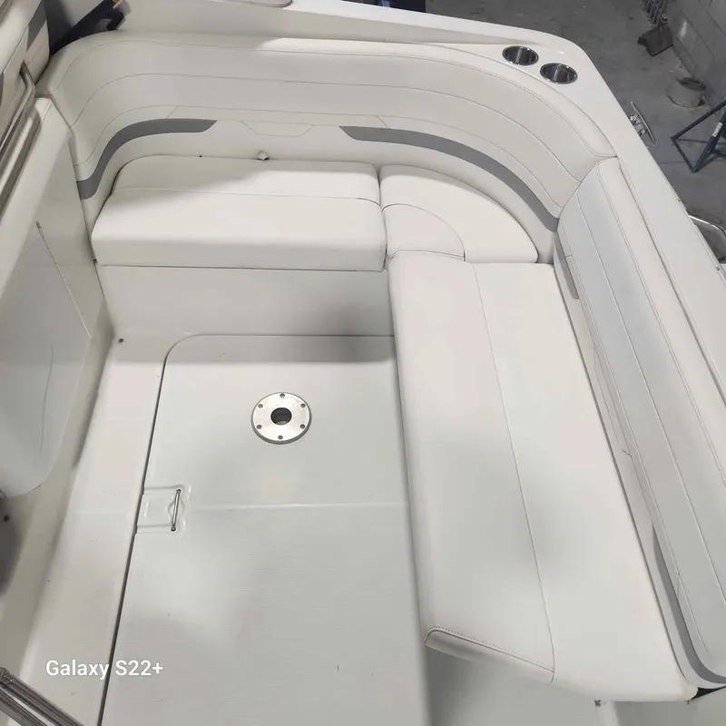 Slide: The Image of 2006 Formula 27 PC boat interior with white seating and cup holders. - 19