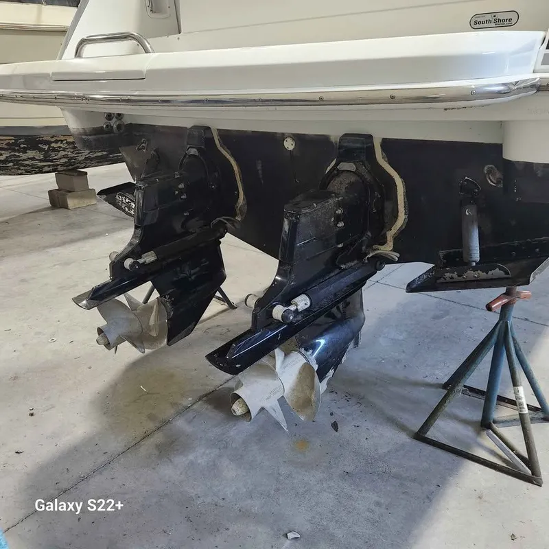 Slide: The Image of 2006 Formula 27 PC boat with dual propellers on stands in a garage. - 3