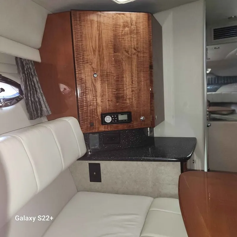 Slide: The Image of Interior of 2006 Formula 27 PC boat with wood cabinetry and white seating. - 6