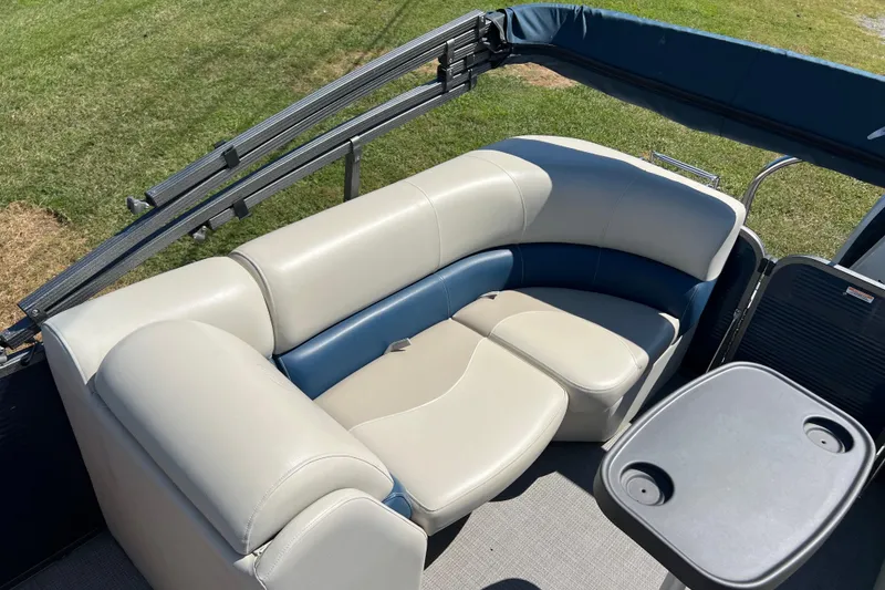 Slide: The Image of 2020 Manitou 23 Aurora LE Standard pontoon boat with comfortable seating and table. - 11