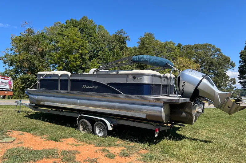 Slide: The Image of 2020 Manitou 23 Aurora LE Standard pontoon boat on trailer, parked on grass. - 3