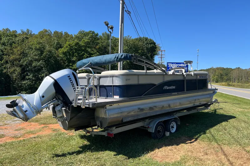 Slide: The Image of 2020 Manitou 23 Aurora LE Standard pontoon boat on trailer, parked roadside. - 4
