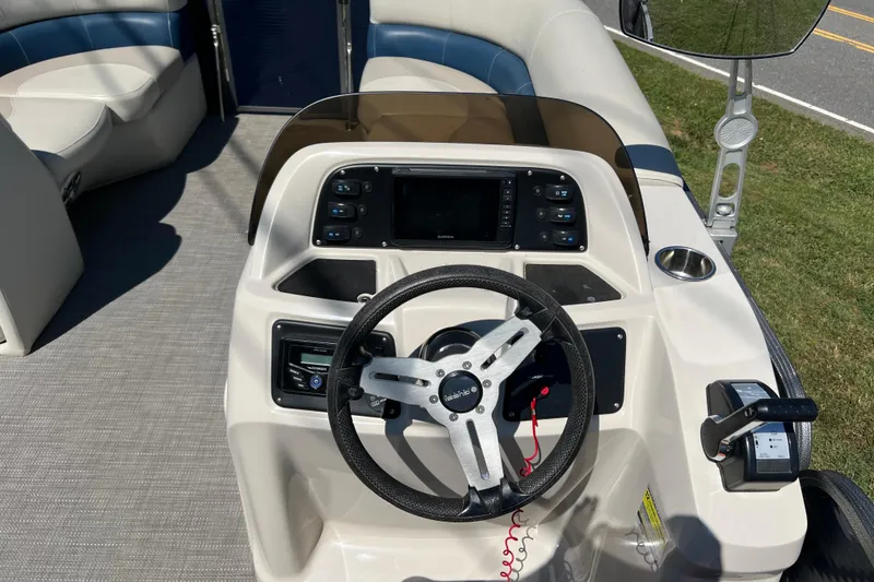 Slide: The Image of 2020 Manitou 23 Aurora LE Standard boat dashboard with steering wheel and controls. - 8