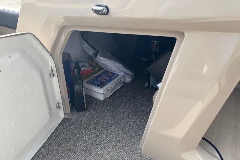 Slide: The Image of Storage compartment in 2023 Viaggio DIAMANTE 23S boat, containing various items and equipment. - 16