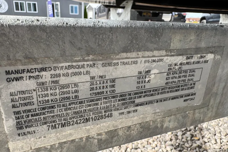 Slide: The Image of Label on trailer showing specifications and safety standards compliance, manufactured by Genesis Trailers. - 19