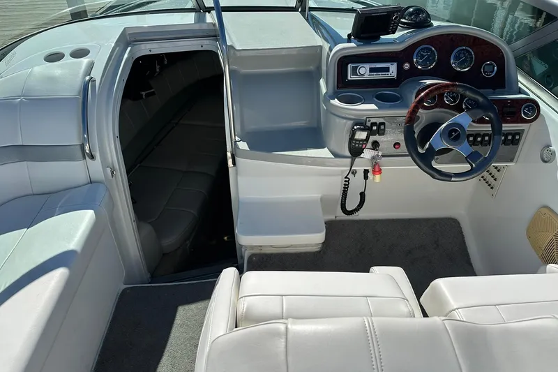 Slide: The Image of 2005 Formula 260 Sun Sport boat interior with steering wheel, dashboard, and cabin entrance. - 11