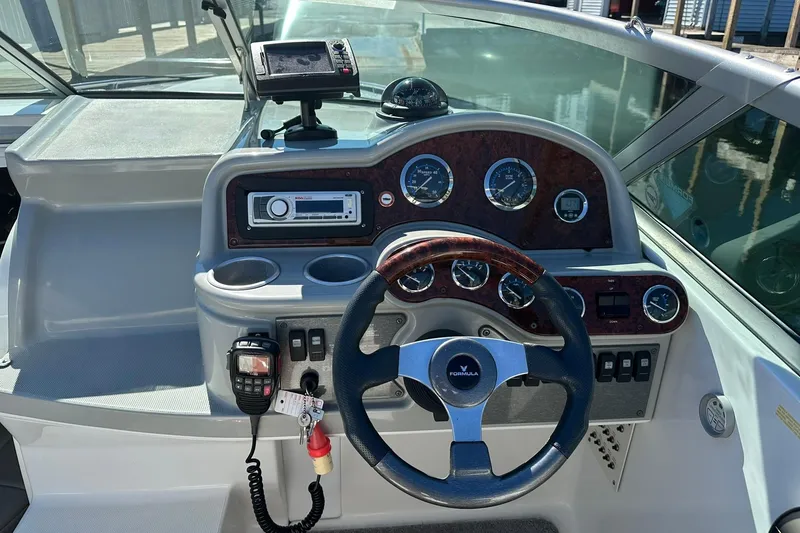 Slide: The Image of Dashboard of a 2005 Formula 260 Sun Sport boat with steering wheel and gauges. - 12