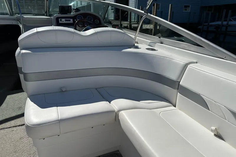 Slide: The Image of 2005 Formula 260 Sun Sport boat interior with white seating and dashboard view. - 13