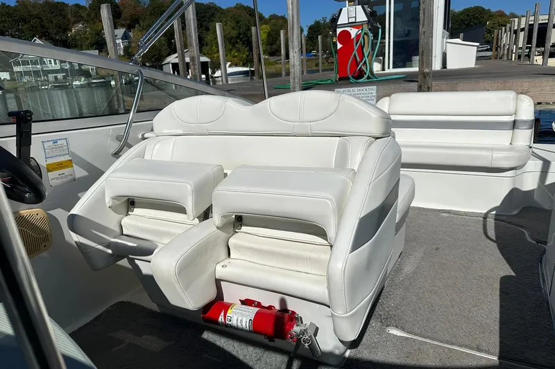 Slide: The Image of 2005 Formula 260 Sun Sport boat interior with white seating and fire extinguisher. - 14