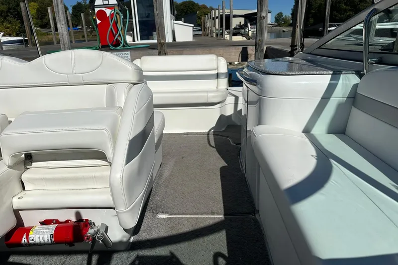 Slide: The Image of Interior of a 2005 Formula 260 Sun Sport boat with white seating and a fire extinguisher. - 15