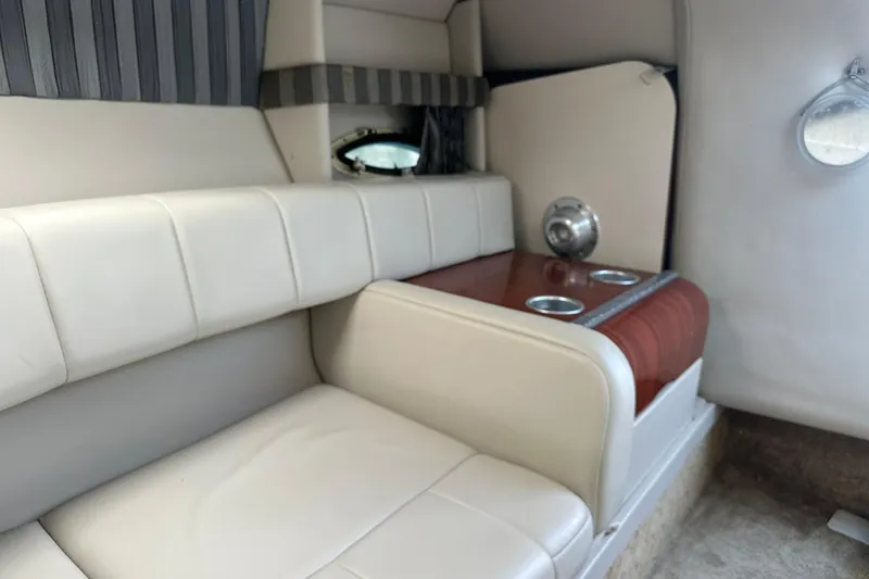 Slide: The Image of 2005 Formula 260 Sun Sport interior with white seating and wooden accents. - 19