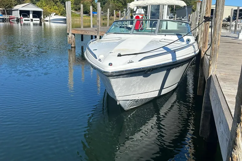 Slide: The Image of 2005 Formula 260 Sun Sport boat docked in a serene marina setting. - 3