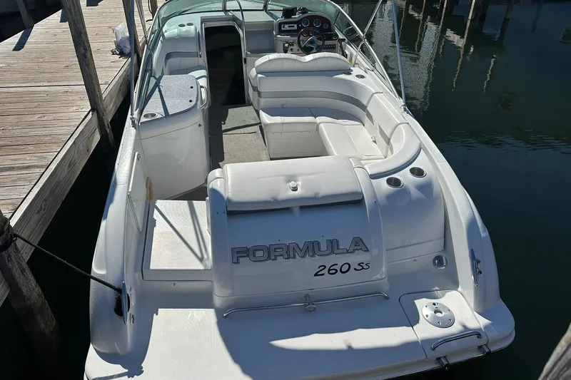 Slide: The Image of 2005 Formula 260 Sun Sport boat docked, featuring spacious seating and sleek design. - 7