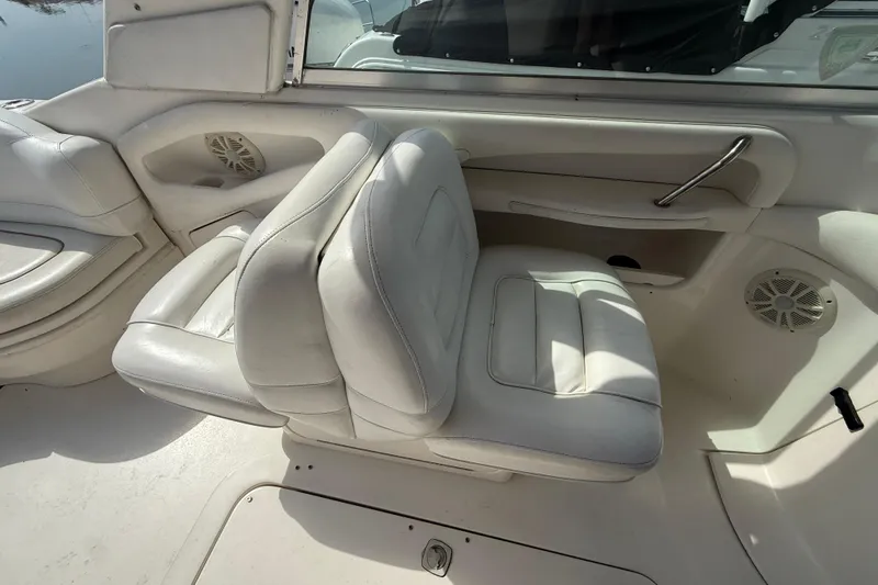 Slide: The Image of 2001 Sea Ray 280 Bow Rider interior with white leather seating and speaker system. - 11