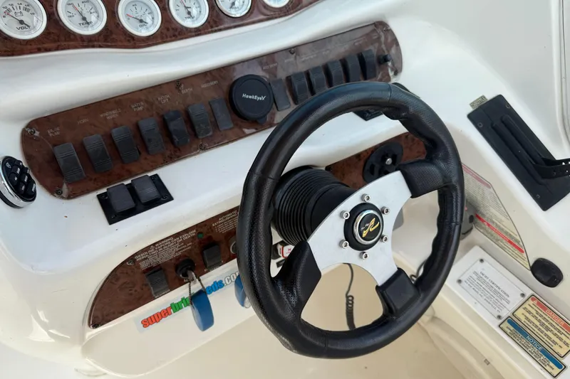 Slide: The Image of Steering wheel and dashboard of 2001 Sea Ray 280 Bow Rider boat. - 14