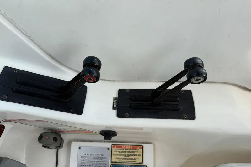 Slide: The Image of Throttle controls on a 2001 Sea Ray 280 Bow Rider boat dashboard. - 15