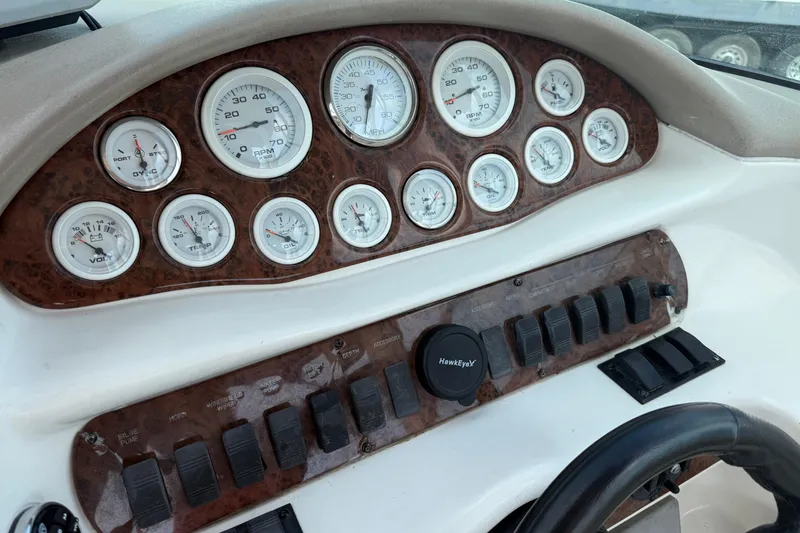 Slide: The Image of Dashboard of a 2001 Sea Ray 280 Bow Rider boat with gauges and controls. - 16