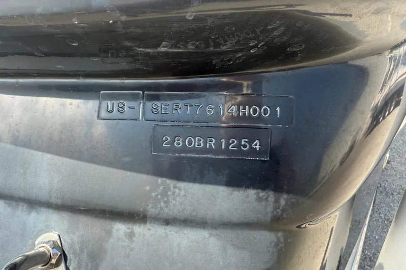 Slide: The Image of 2001 Sea Ray 280 Bow Rider hull identification number on black surface. - 5