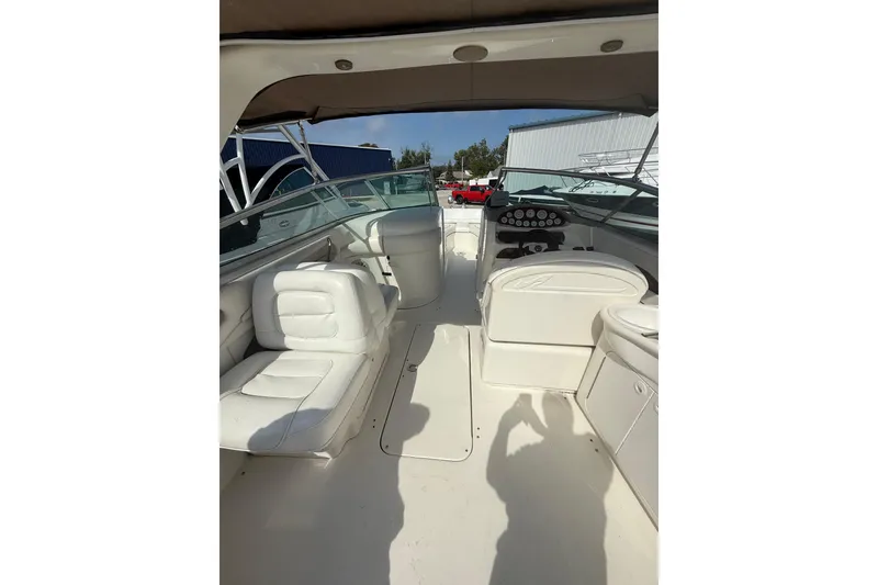 Slide: The Image of 2001 Sea Ray 280 Bow Rider interior with white seating and dashboard. - 6
